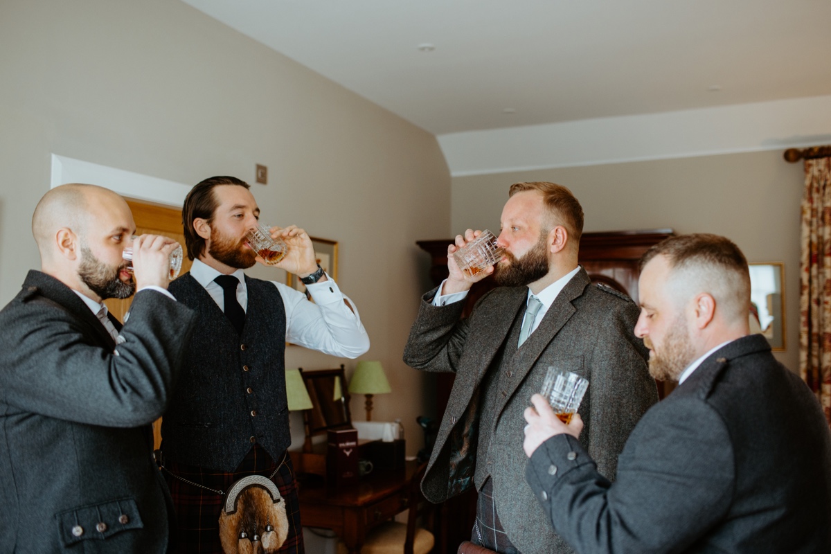 groom and best men all drinking a dram of whisky in room scottish humanist wedding