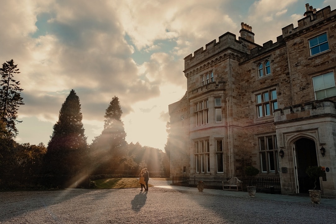 beautiful sunflare photo of couple at crossbasket castle