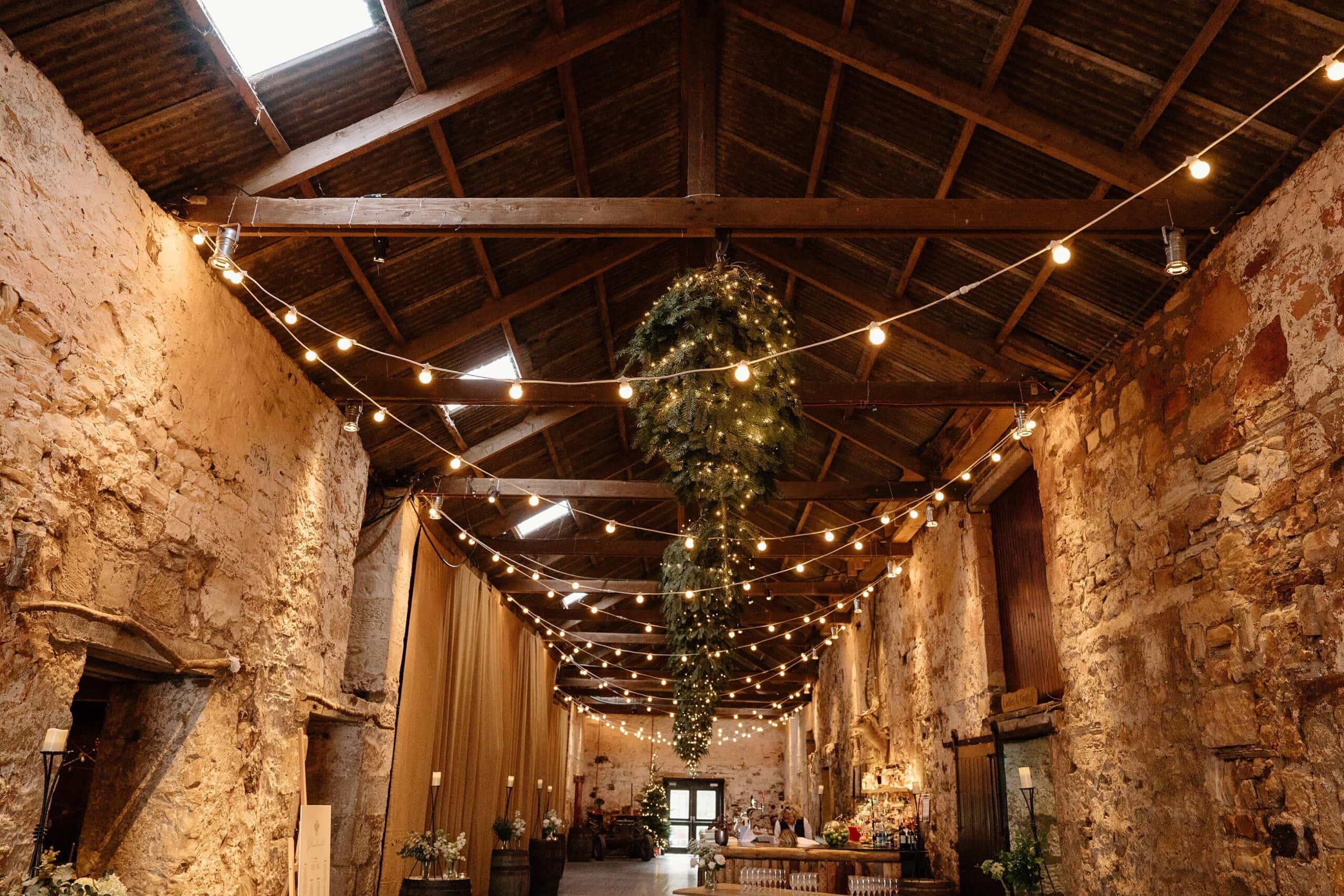 kinkell byre wedding photos interior inside view of farm barn wedding venue st andrews scotland with fairy lights