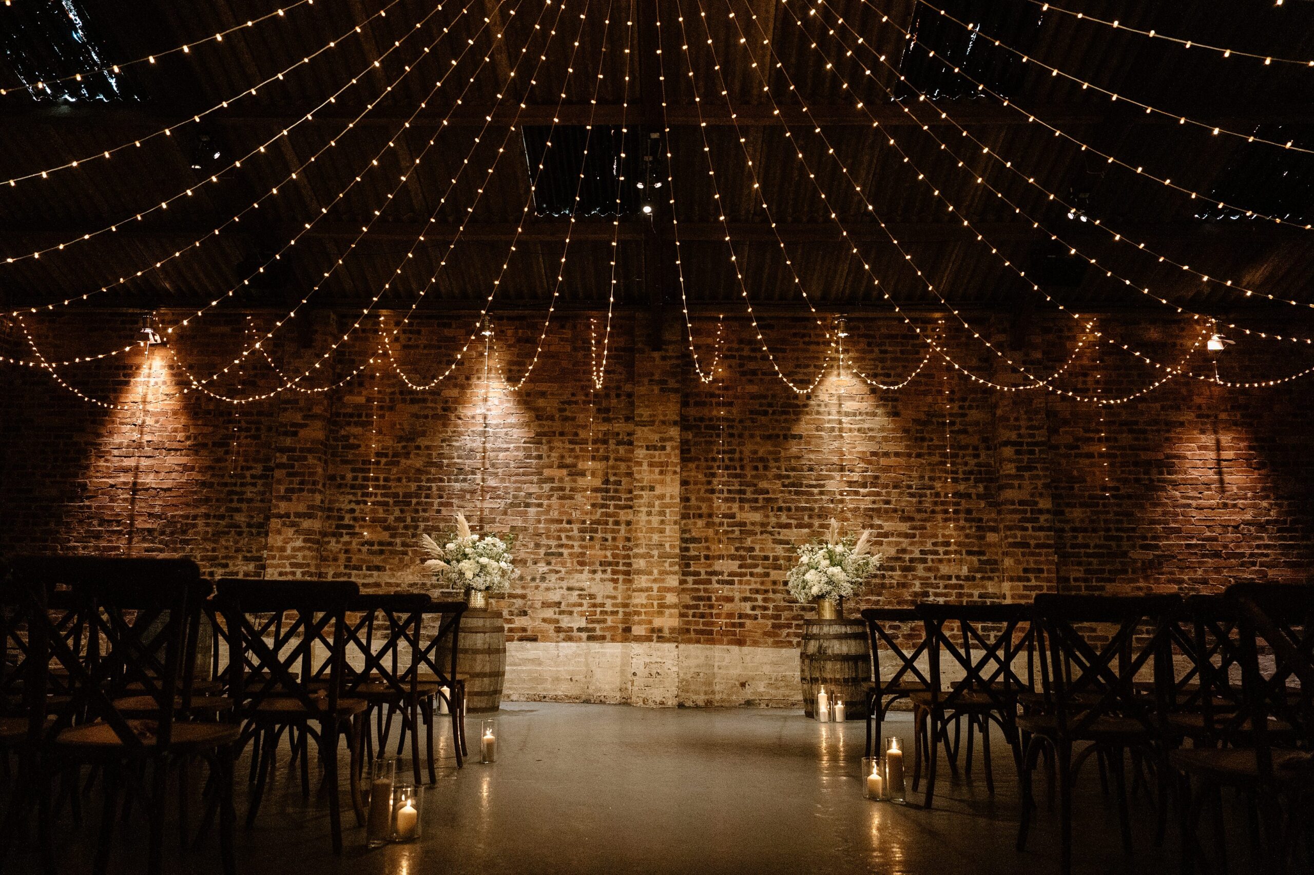kinkell byre wedding photos interior inside view of farm barn wedding venue st andrews scotland ceremony setup with fairy lights