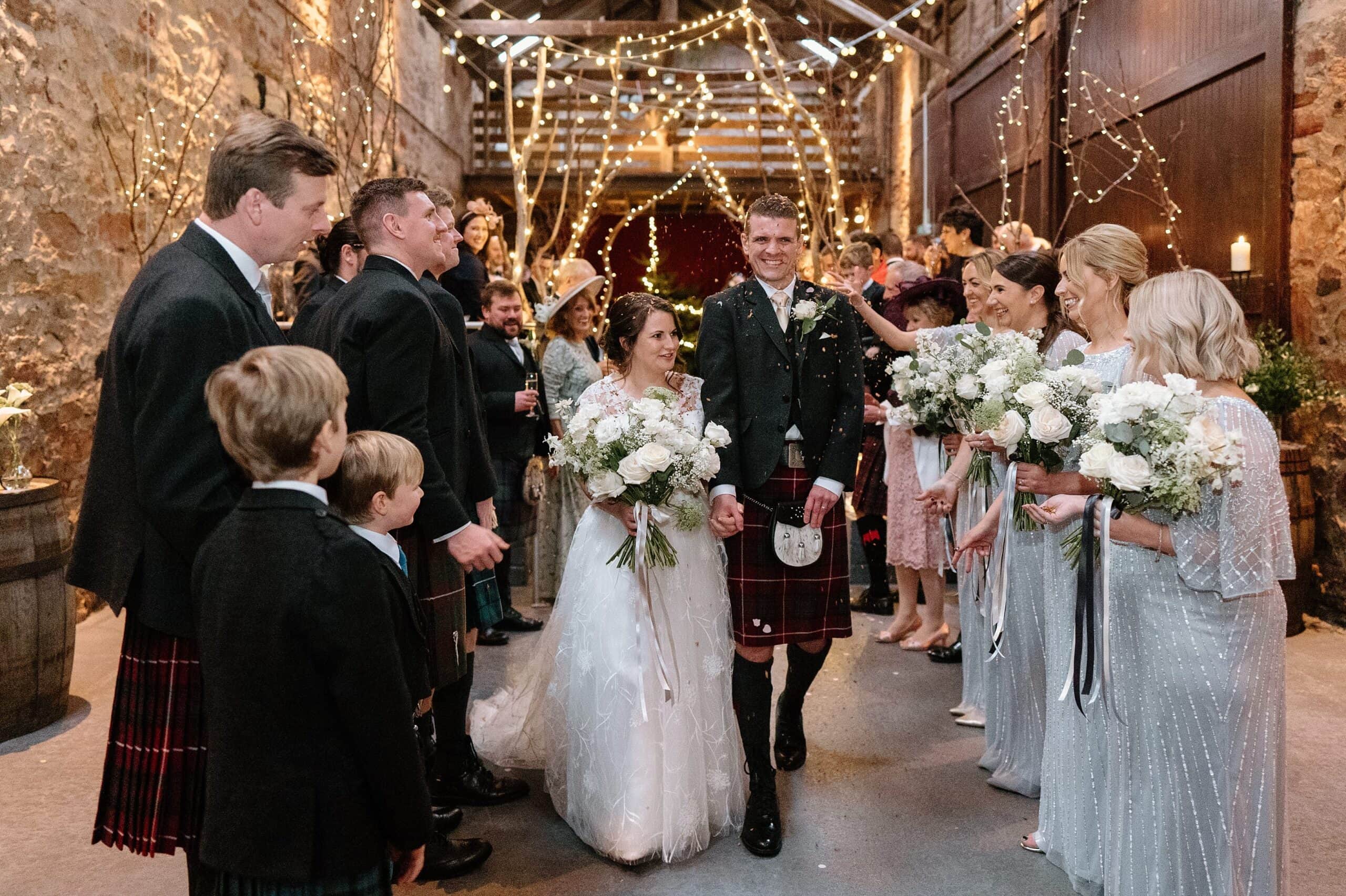 kinkell byre wedding photos interior inside view of farm barn wedding venue st andrews scotland with fairy lights with bride and groom