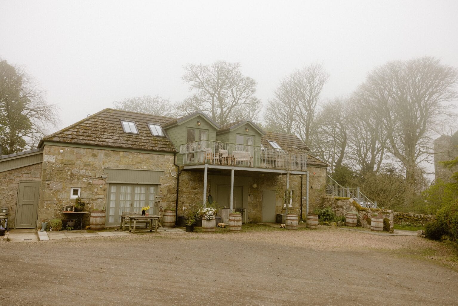 exterior outside view of a stone building barn wedding venues west lothian scotland on a foggy spring morning