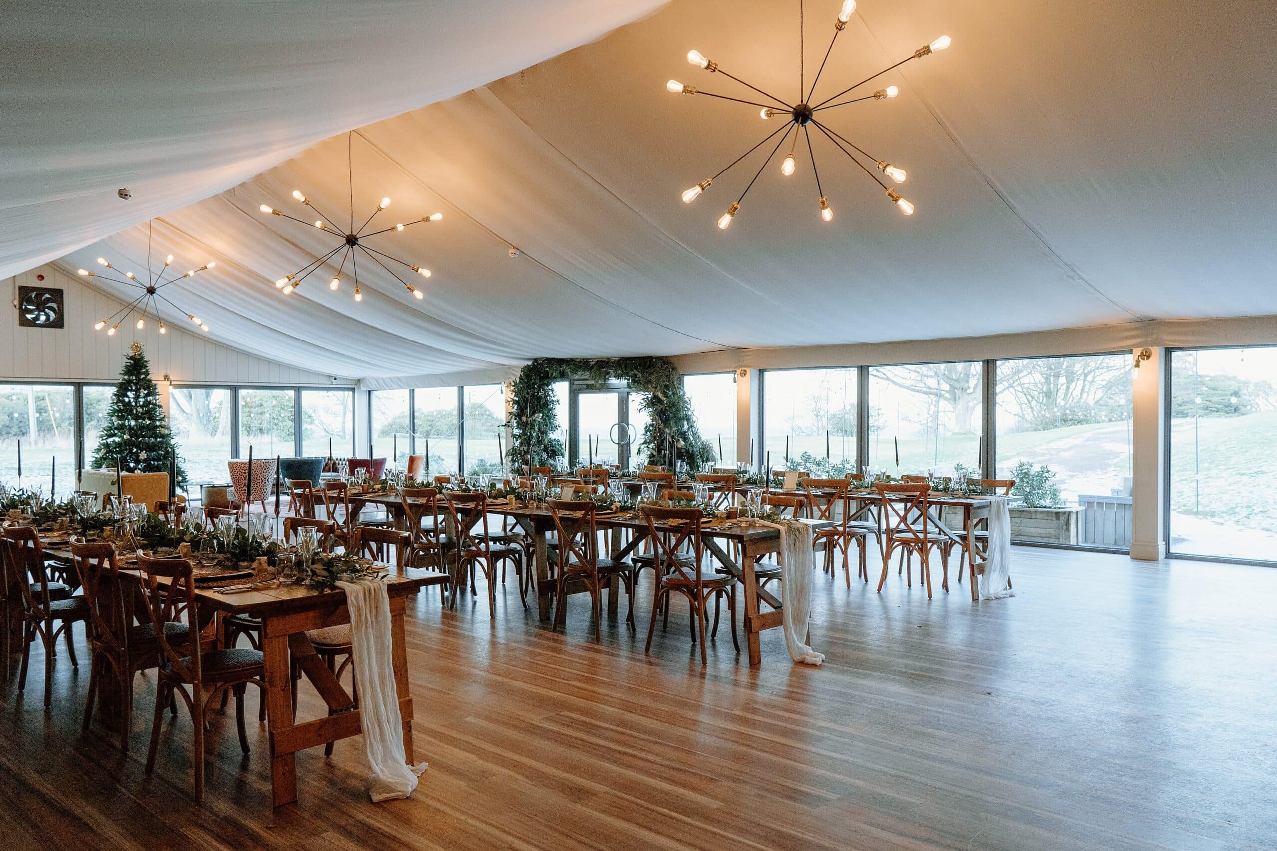 internal interior view of dunglass estate wedding photos of wedding reception dinner setup long trestle tables with foliage