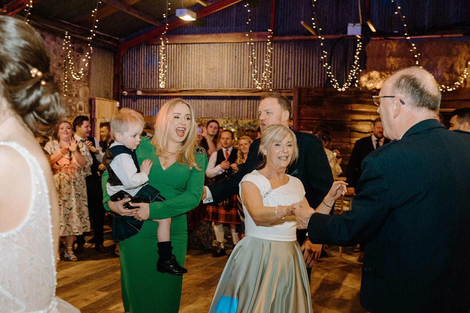 guests dancing beneath festoon lighting at a wedding reception at a farm wedding venue near glasgow scotland