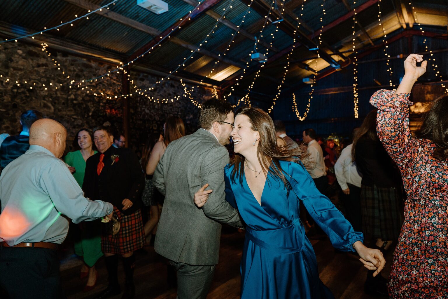 guests dancing beneath festoon lighting at a wedding reception at a farm wedding venue near glasgow scotland