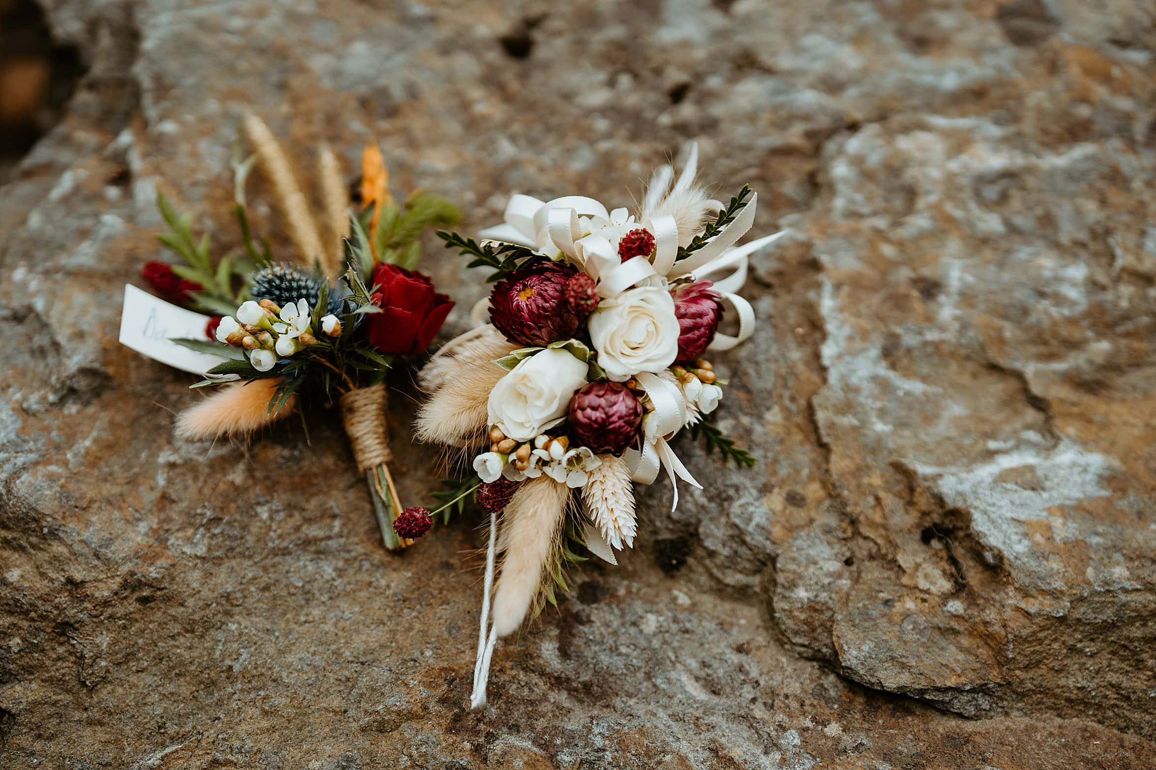 close up of floral bouquets against natural rock cardney steading wedding venue