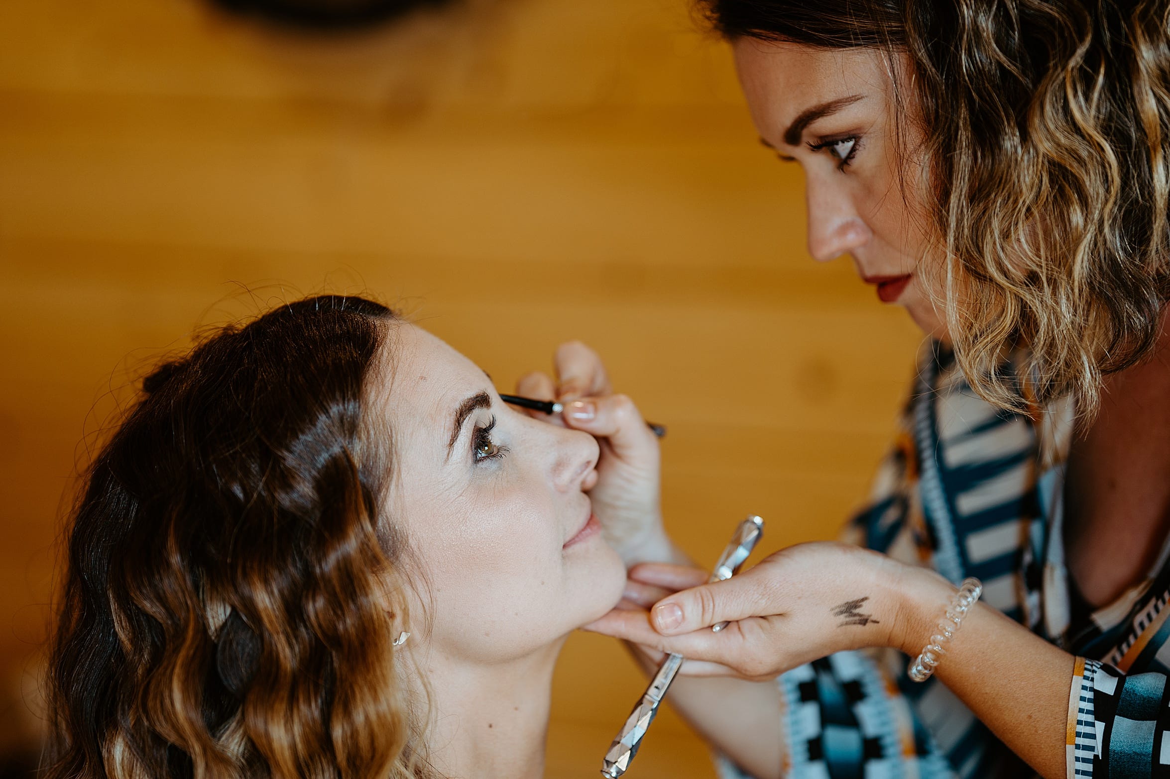bride having her makeup done in wooden cabin cardney steading exclusive use wedding venue