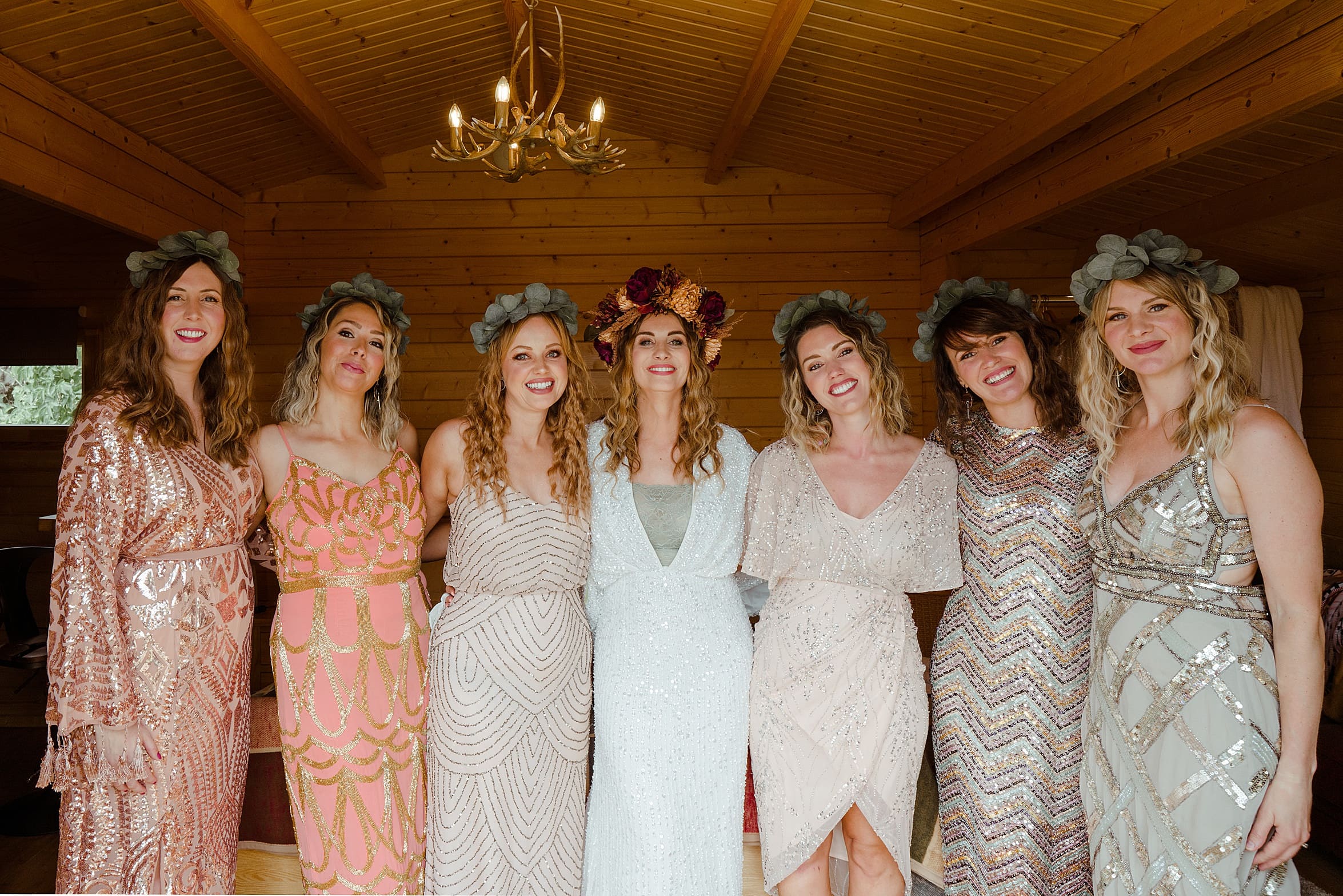 bride and brodesmaids posing in bohemian dresses and floral crowns cardney steading