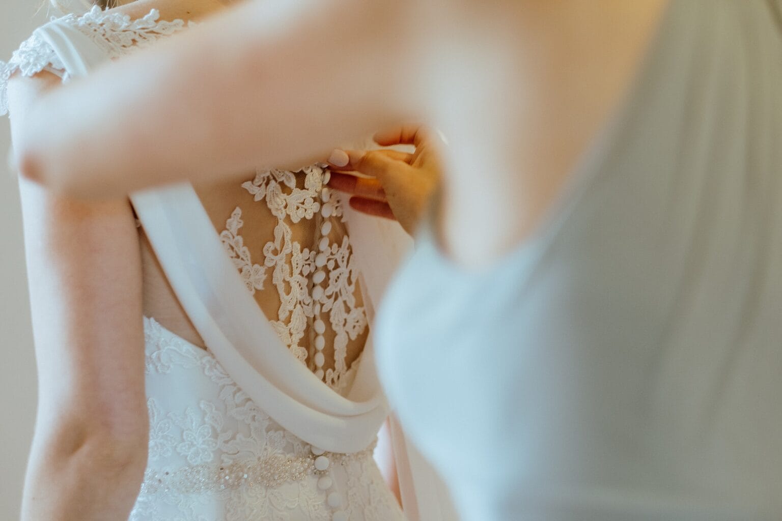 close up of brides dress from the back as it is zipped up colstoun house wedding edinburgh unique wedding venue scotland