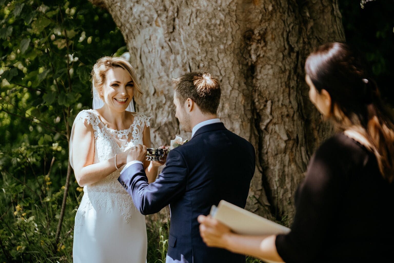 bride smiling as her and groom hold quaich in front of big tree colstoun house wedding unique venues scotland unique wedding venue scotland