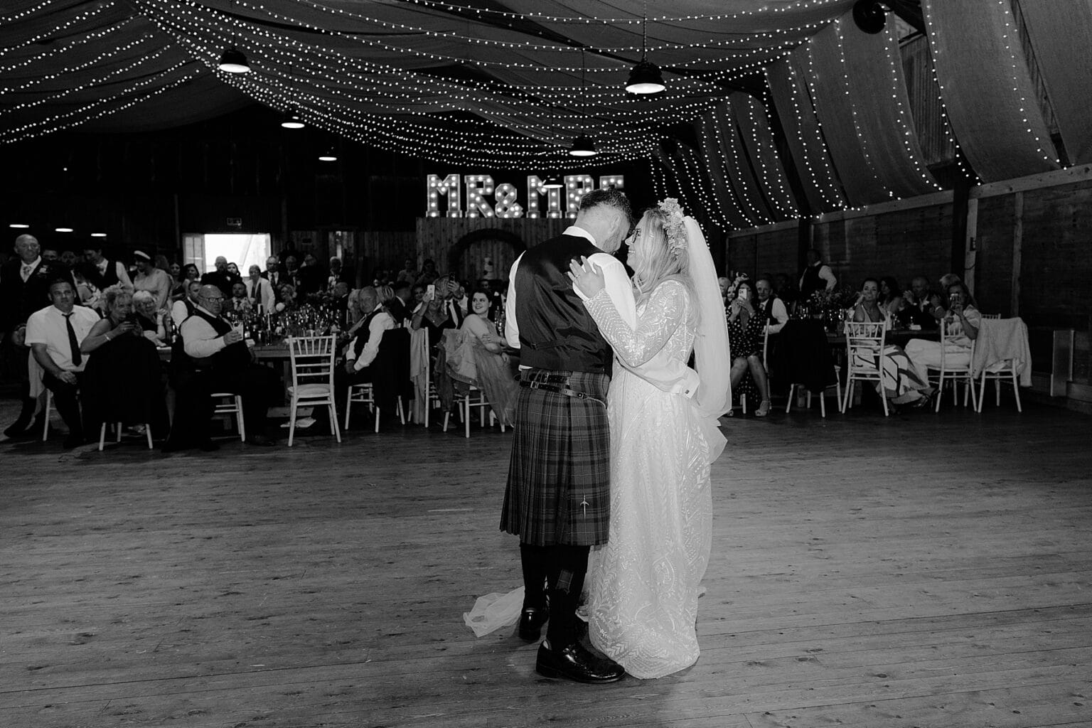 bride and groom during their first dance inside barn at the den at culross wedding