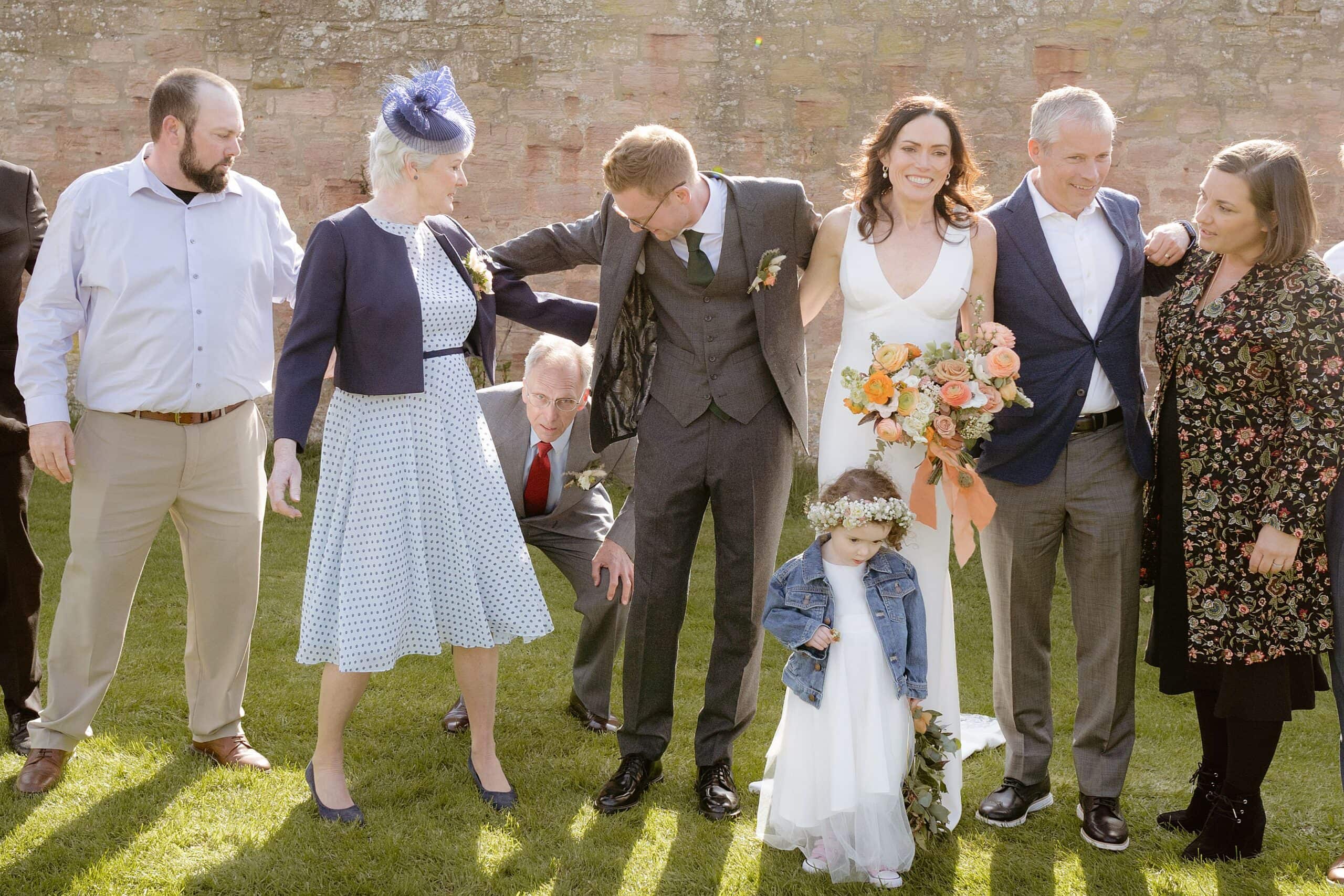 documentary shot of the bride and groom and guests following their joyful wedding at an outdoor wedding venue